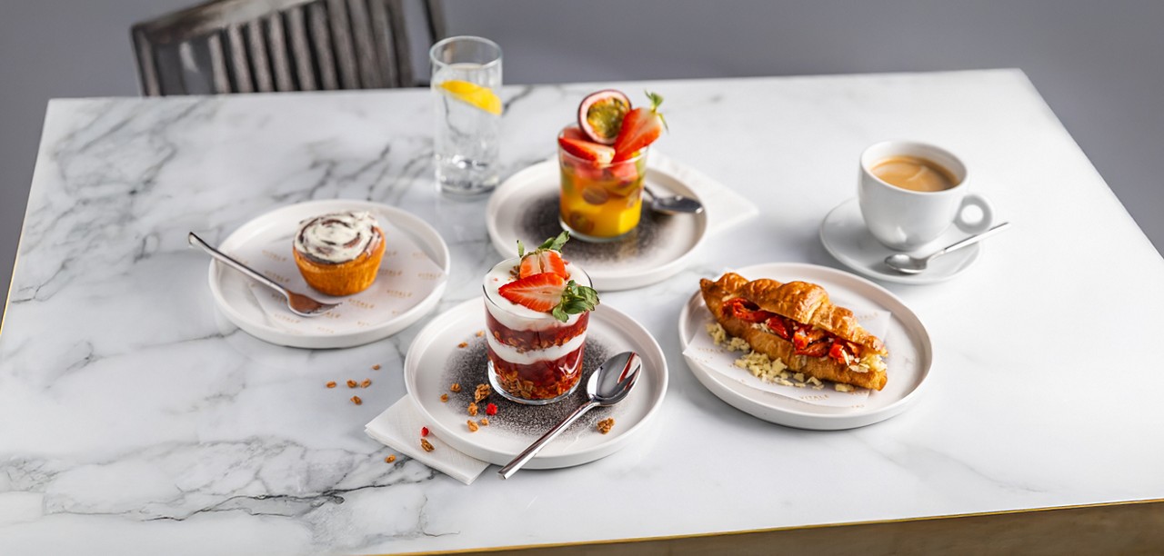 A selection of breakfast items including granola and fruit salad.